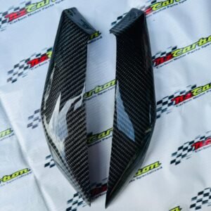 NZ Carbon Side Body Protector for Yamaha XMAX V2 & V3 in Black Twill Carbon, displayed on an NZ Motor Parts branded background showing the carbon weave and compact protective design.