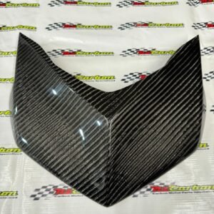 Big Twill Carbon Front Cover Shield (Dada) for Yamaha XMAX V2 displayed on an NZ Motor Parts backdrop, showing the bold twill pattern and glossy carbon finish.