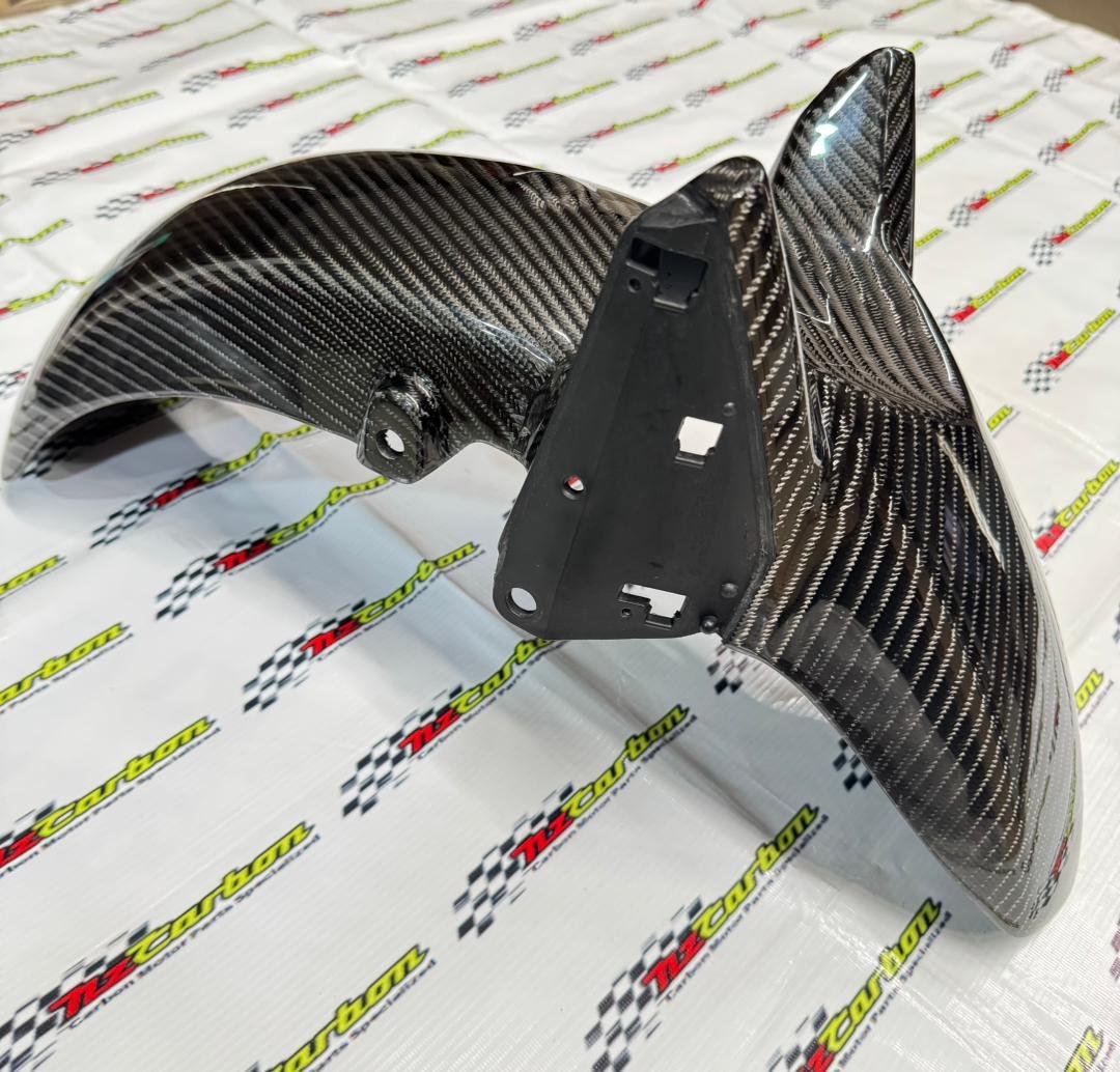 Big Twill Carbon Front Fender for Yamaha XMAX V2 & V3 displayed on NZ Motor Parts’ branded backdrop, showing the 3D twill weave texture and glossy finish.