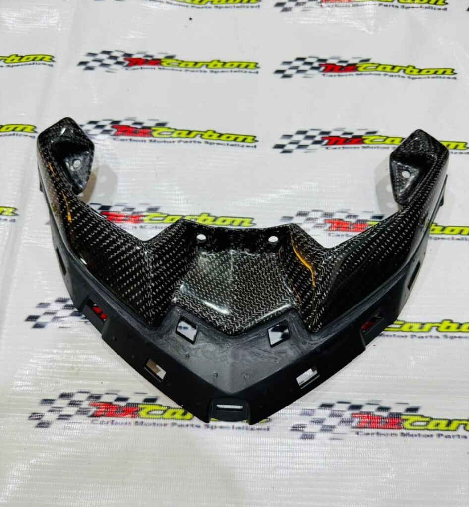Upper Front Signal Cover in Black Twill Carbon for Yamaha XMAX V3, displayed on an NZ Carbon / NZ Motor Parts branded background showing the carbon fiber texture and detailed craftsmanship.