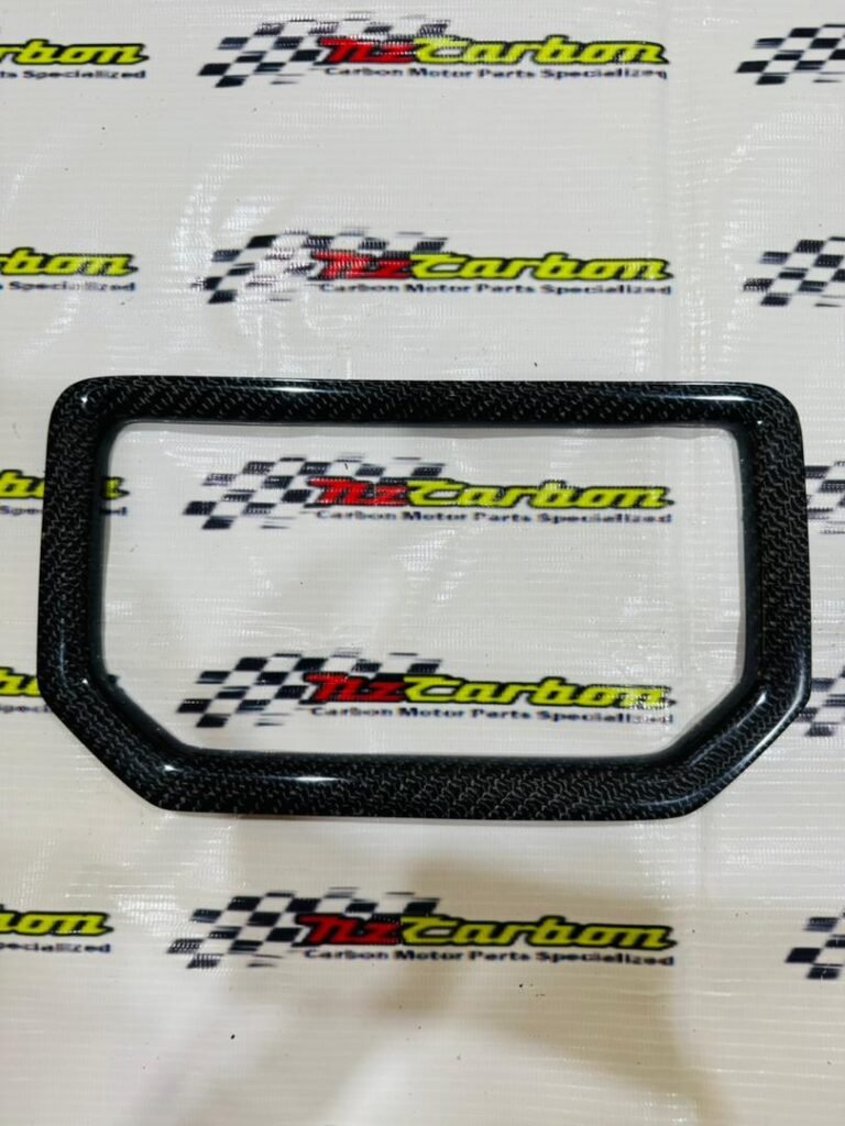 Black Twill Carbon Speed Meter Cover for Yamaha XMAX V3 displayed on an NZ Motor Parts backdrop, showing the carbon weave texture and smooth glossy finish.